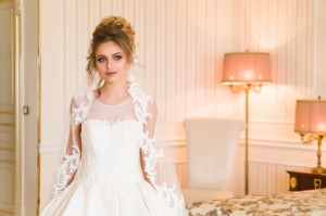 Portrait of beautiful young bride. A girl is posing in a hotel room. A lady Is worth with by the window. bride waiting in hotel